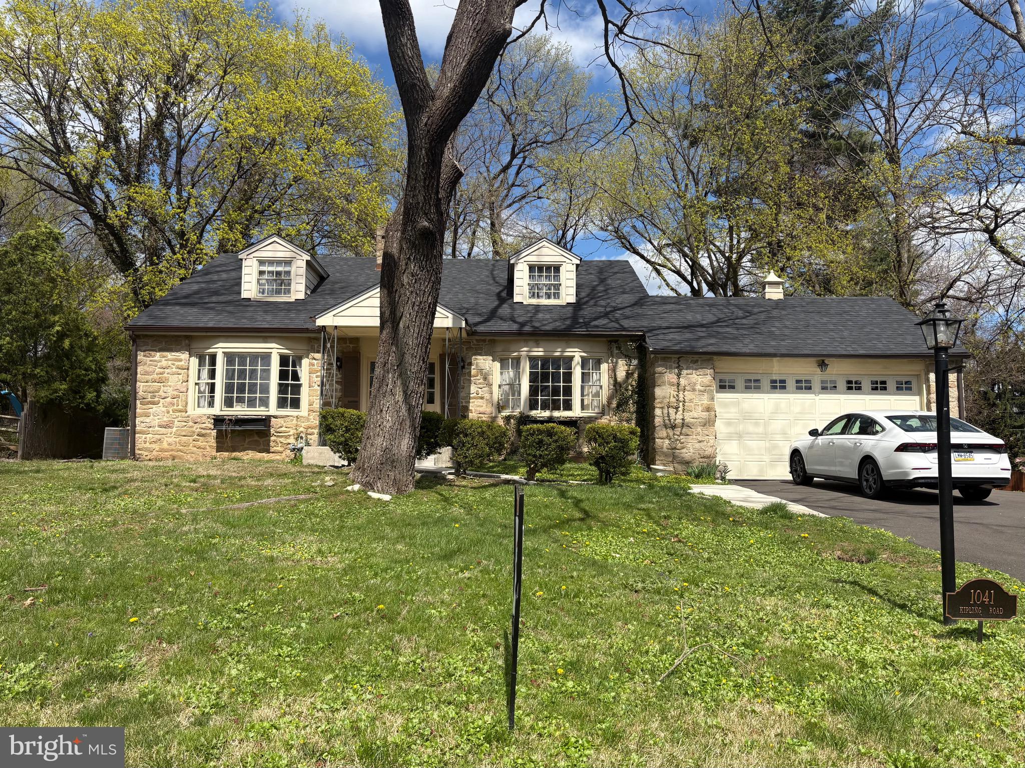 a view of a house with a yard and sitting area
