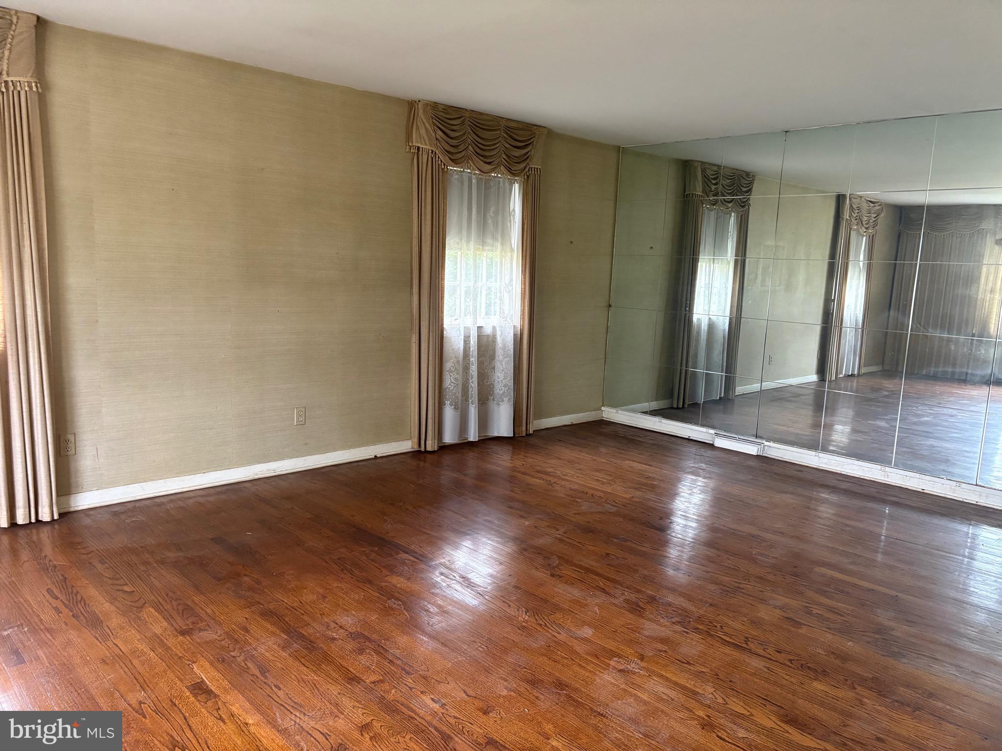 1041 Kipling Road Jenkintown, PA 19046 - Photo 12 of 23 an empty room with wooden floor and windows