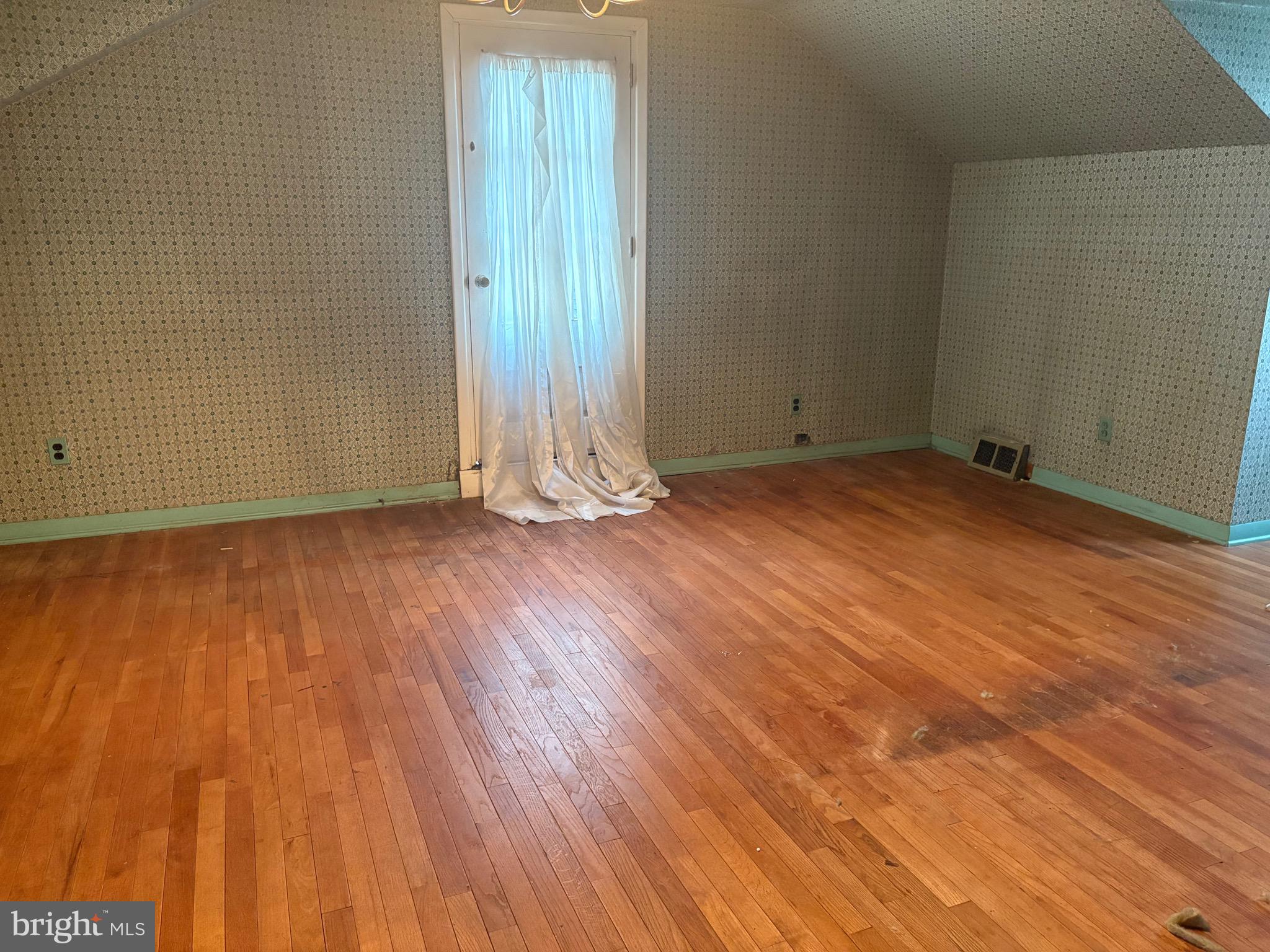 1041 Kipling Road Jenkintown, PA 19046 - Photo 15 of 23 an empty room with wooden floor and windows