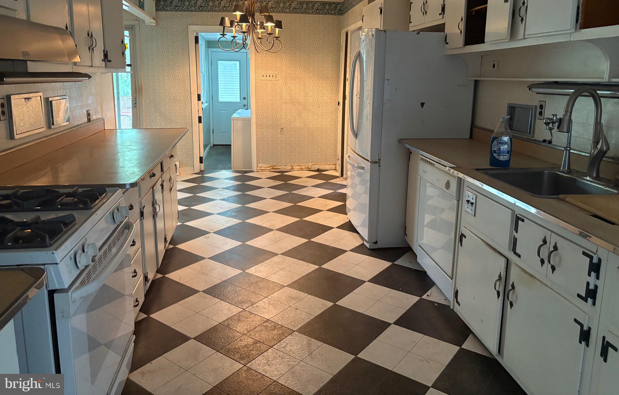 1041 Kipling Road Jenkintown, PA 19046 - Photo 4 of 23 a kitchen with a checkered floor and a stove top oven