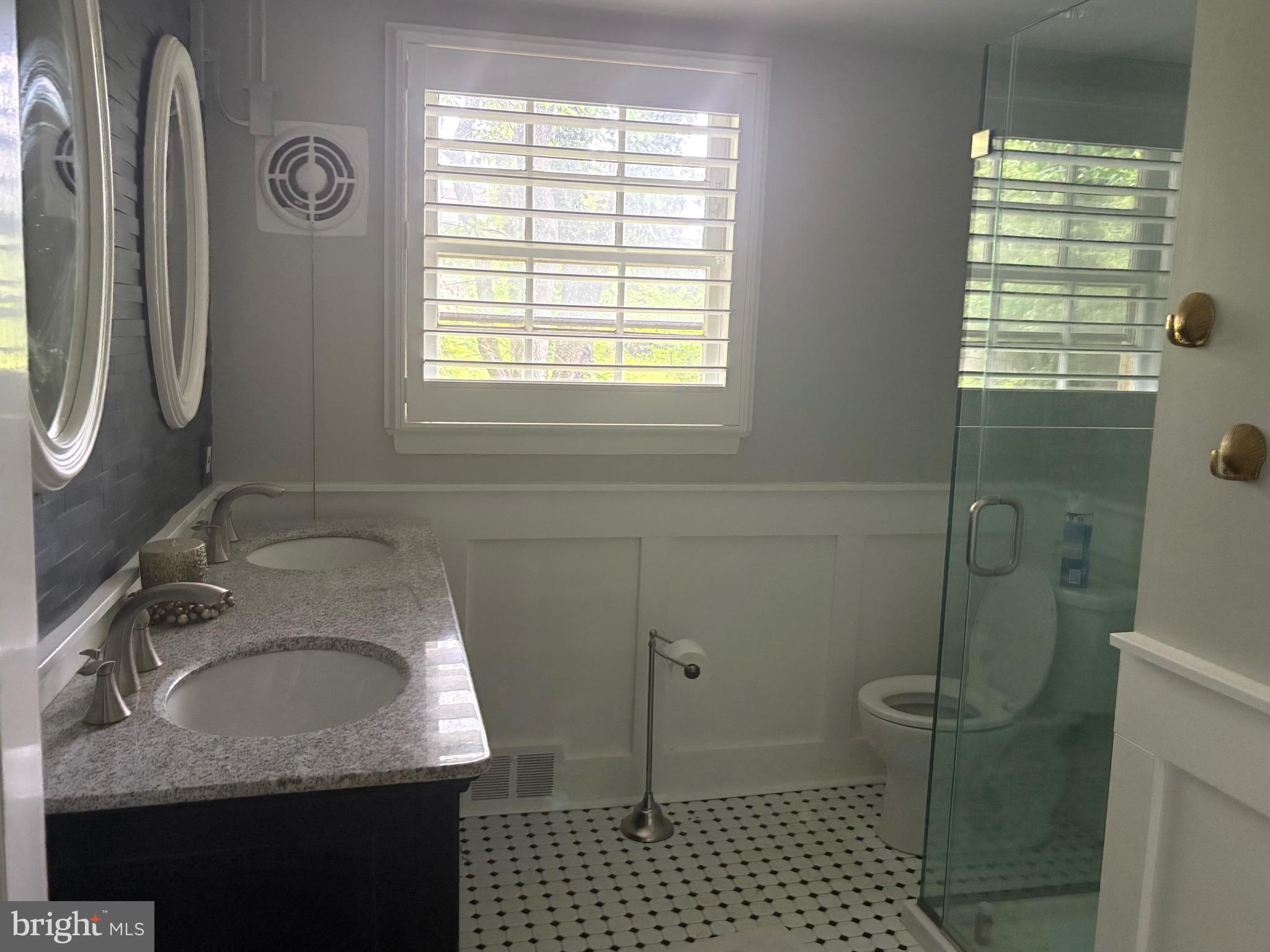 1041 Kipling Road Jenkintown, PA 19046 - Photo 9 of 23 a bathroom with a granite countertop sink a toilet and a shower