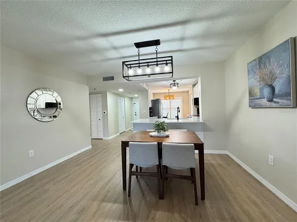 a view of a dining room with furniture wooden floor and a window