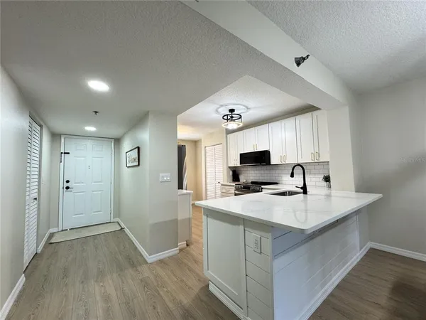 a kitchen with a sink a stove a refrigerator and a stove