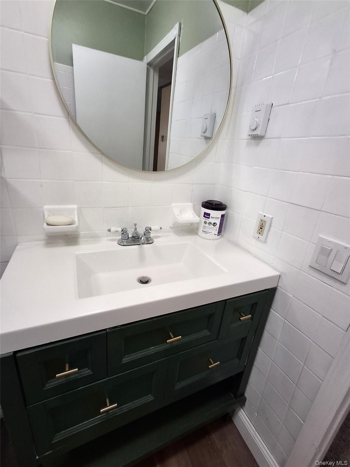 18 White Gate Road, Unit C Wappingers Falls, NY 12590 - Photo 12 of 21 a bathroom with a sink vanity and a mirror