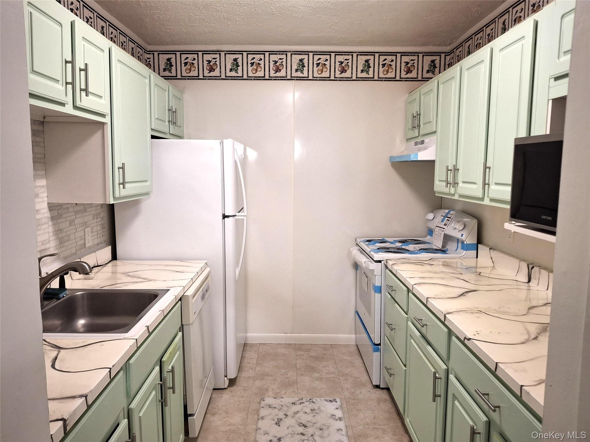 18 White Gate Road, Unit C Wappingers Falls, NY 12590 - Photo 6 of 21 a kitchen with a sink stove and refrigerator