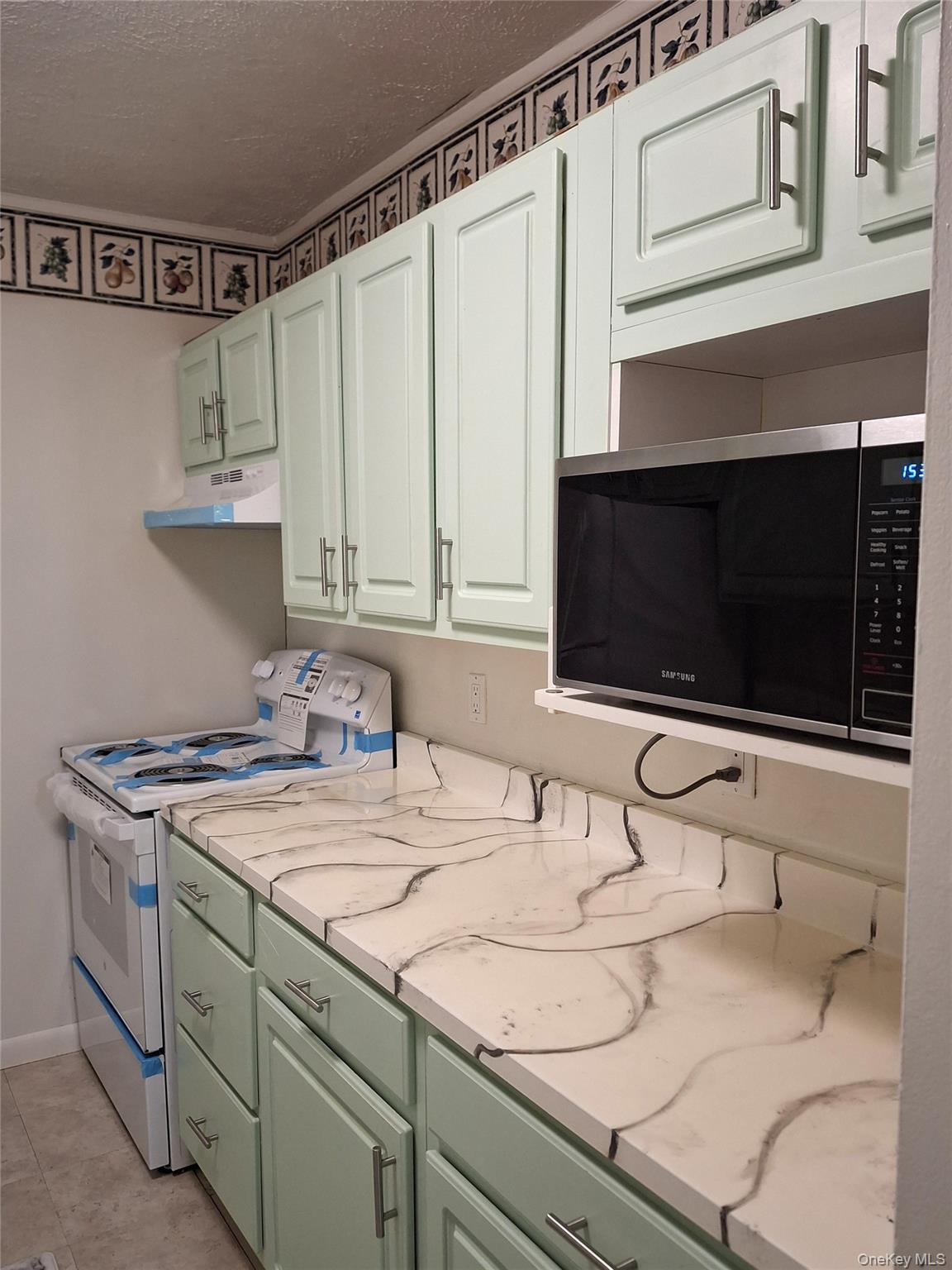 18 White Gate Road, Unit C Wappingers Falls, NY 12590 - Photo 7 of 21 a kitchen with stainless steel appliances a stove microwave and cabinets