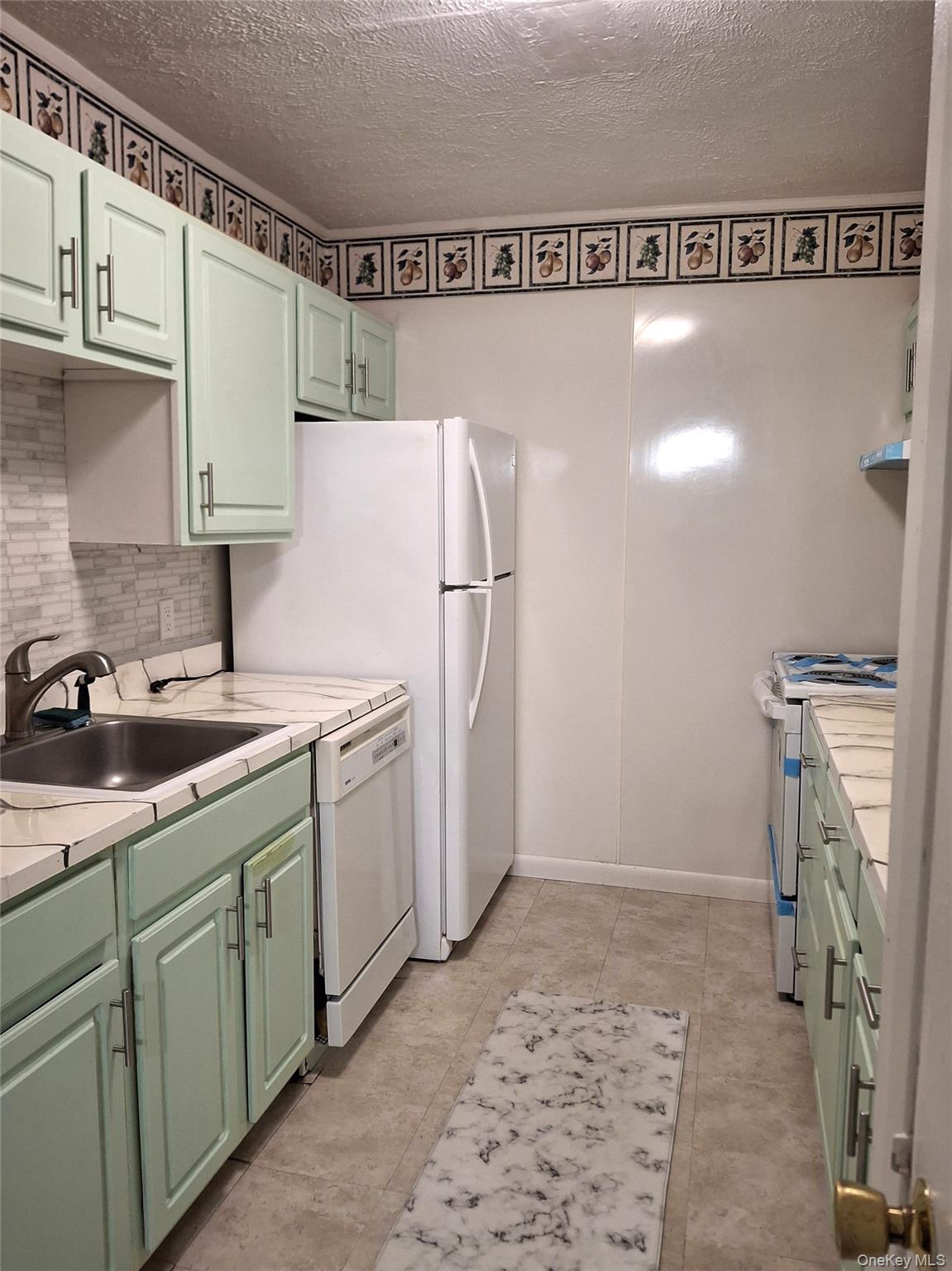 18 White Gate Road, Unit C Wappingers Falls, NY 12590 - Photo 8 of 21 a kitchen with a sink and a refrigerator