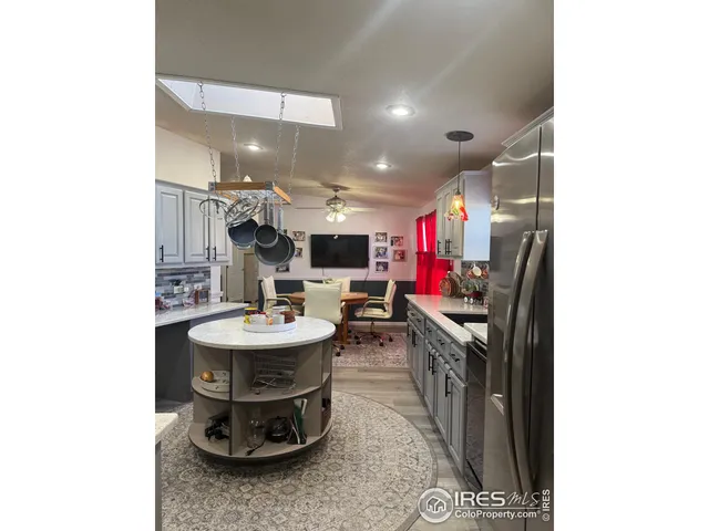 a kitchen with kitchen island a sink and a stove