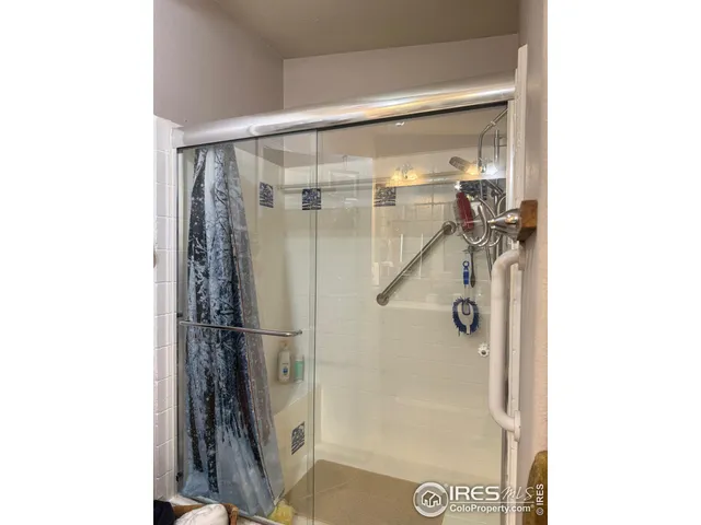 a bathroom with a glass shower door