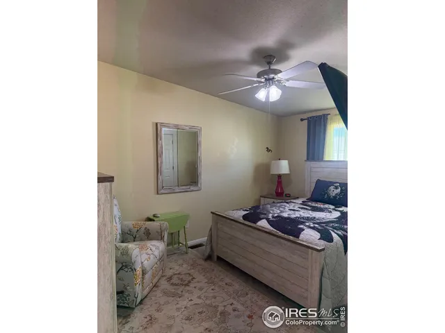 a bedroom with bed and a chandelier