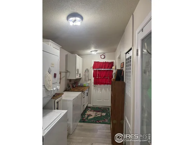 a kitchen with refrigerator and cabinets
