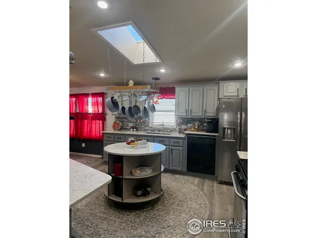 a kitchen with a sink cabinets and appliances
