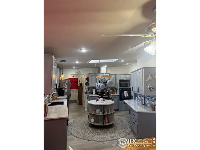 a room with lots of counter space and a refrigerator