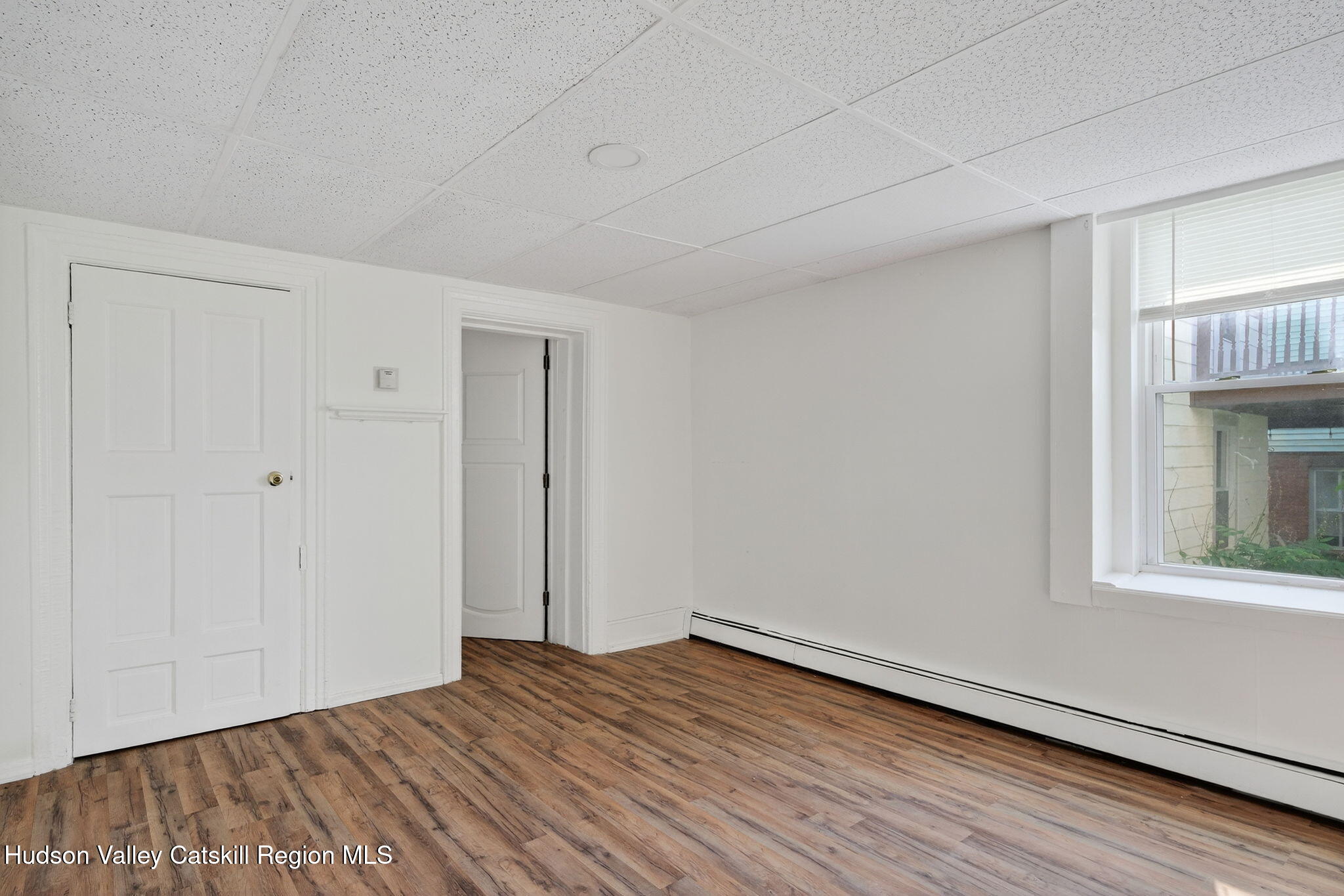 17 New Street, Unit # 3 Catskill, NY 12414 - Photo 16 of 23 a view of an empty room with wooden floor and a window