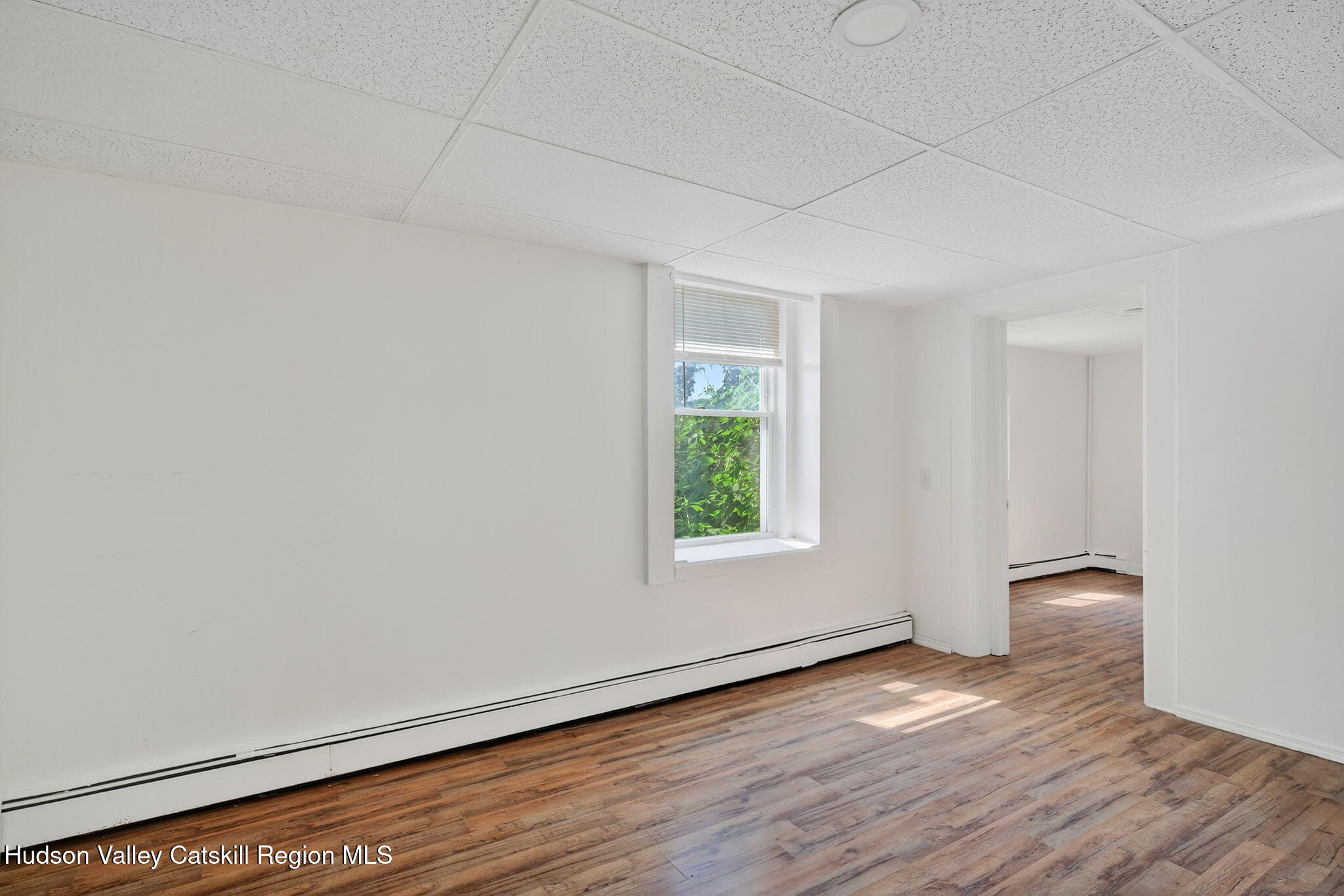 17 New Street, Unit # 3 Catskill, NY 12414 - Photo 17 of 23 an empty room with wooden floor and windows