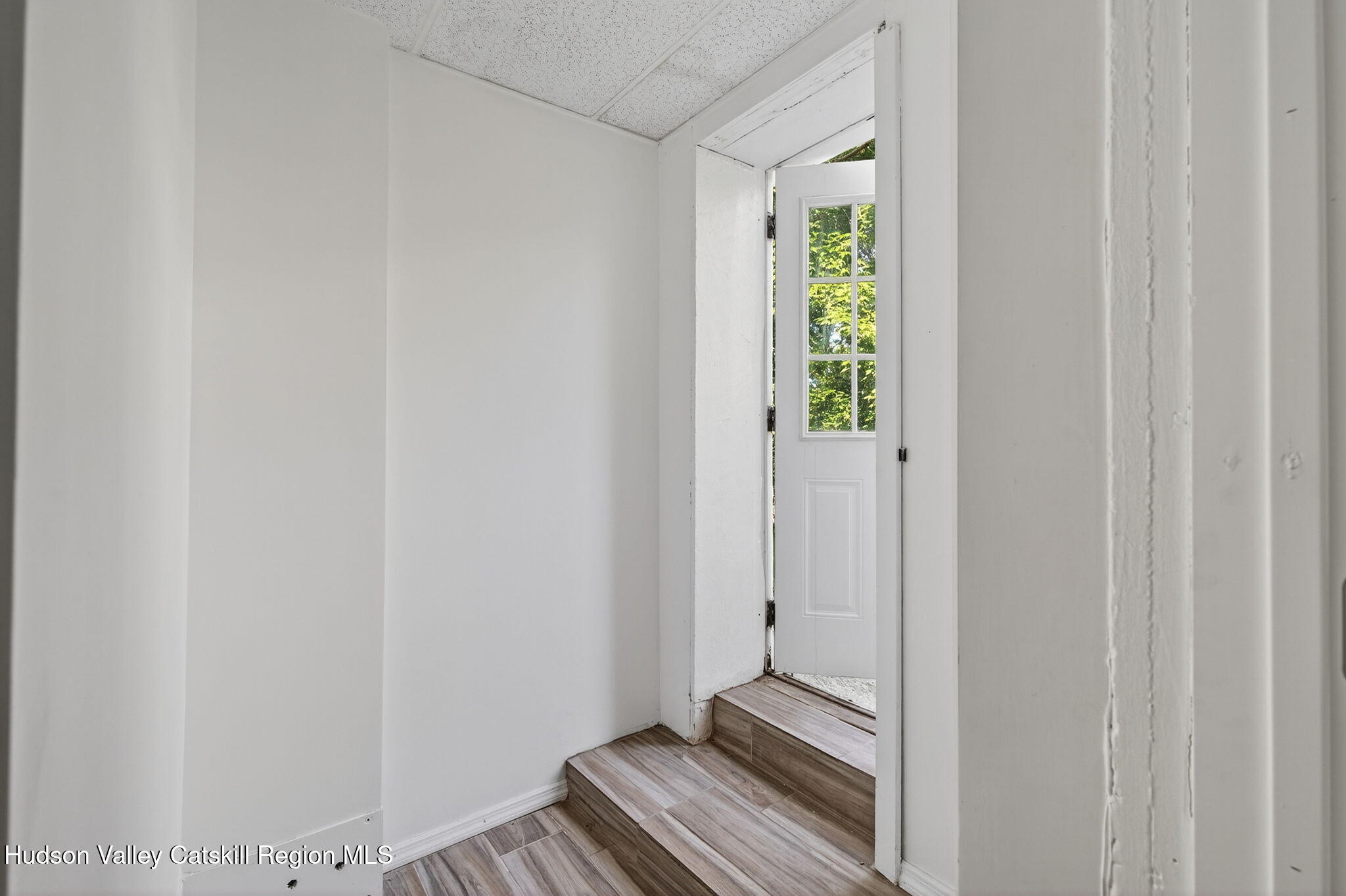 17 New Street, Unit # 3 Catskill, NY 12414 - Photo 2 of 23 a view of a room with wooden floor and small window