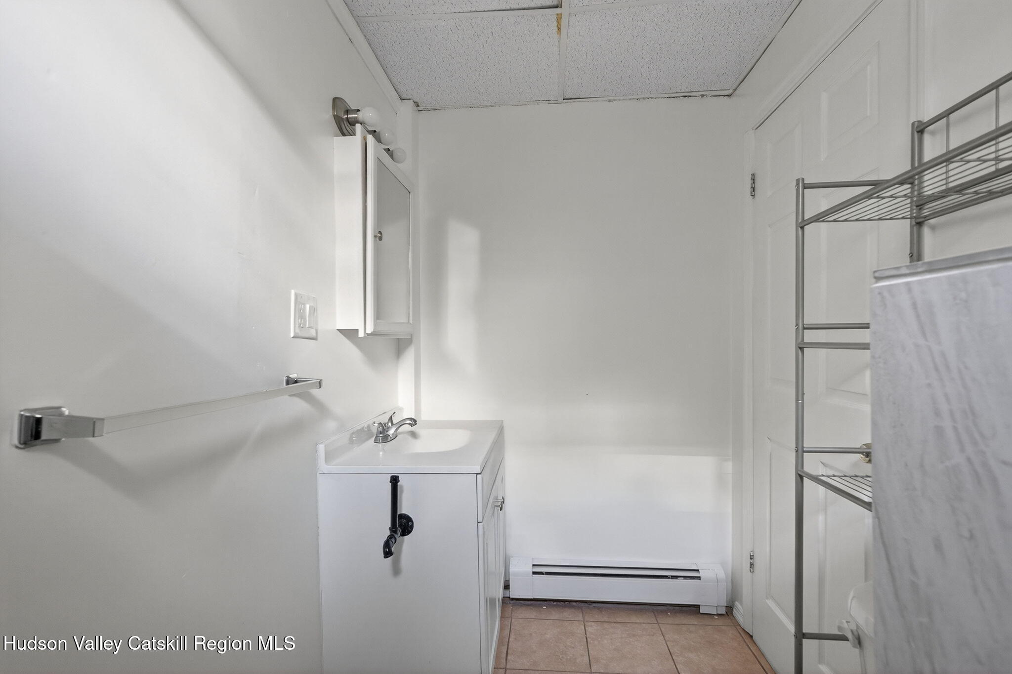 17 New Street, Unit # 3 Catskill, NY 12414 - Photo 21 of 23 a bathroom with a sink a mirror and shower