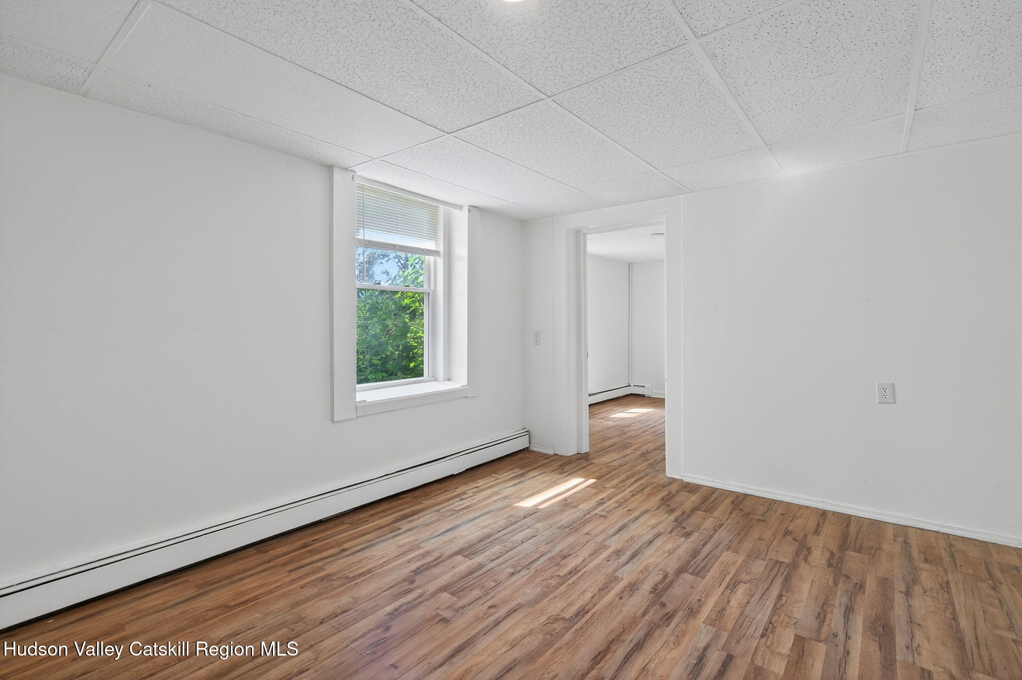 17 New Street, Unit # 3 Catskill, NY 12414 - Photo 9 of 23 an empty room with wooden floor and windows