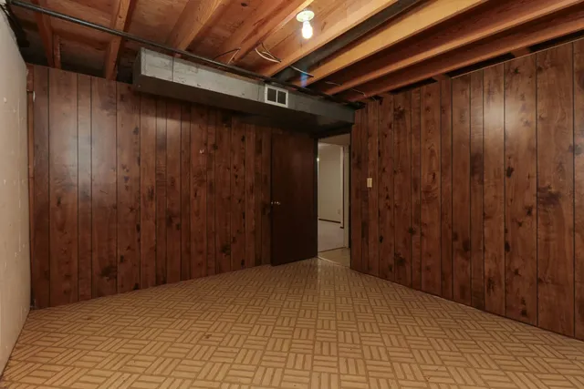 a view of a room with wooden walls