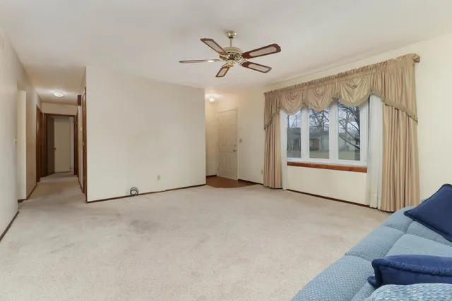 a view of a livingroom with a ceiling fan and window