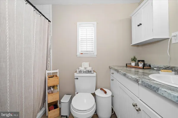 a white toilet sitting next to a bathroom sink