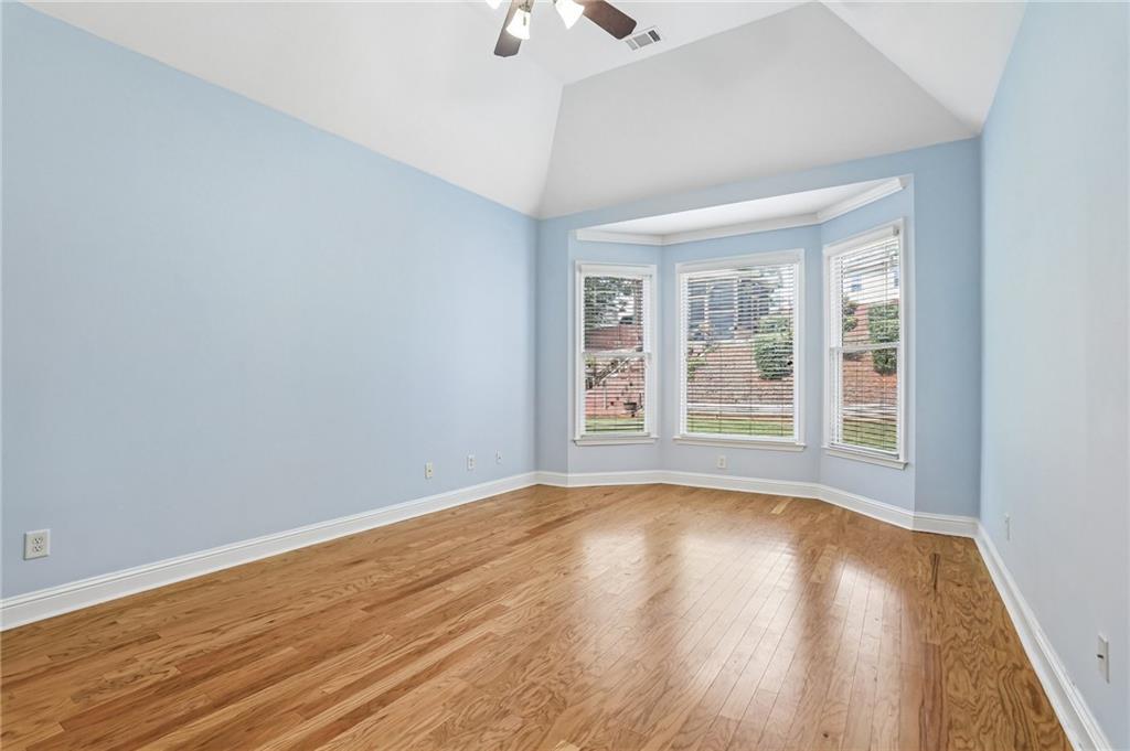 810 Freedom Way Cumming, GA 30040 - Photo 21 of 61 a view of an empty room with wooden floor and a window
