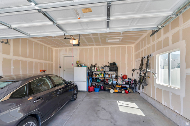 2664 West Maple Street Mapleton, UT 84664 - Photo 36 of 49 Spacious garage featuring concrete flooring, a single window, and an interior access door