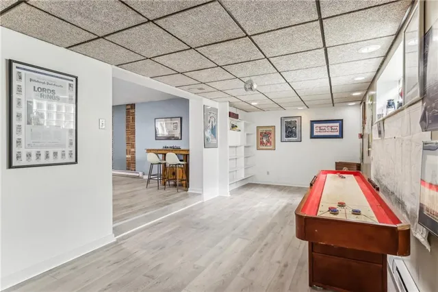 a living room with furniture and a dining table with wooden floor