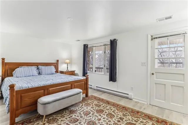 a bedroom with a bed and window