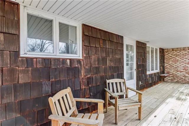 a view of balcony with two chairs and a rug