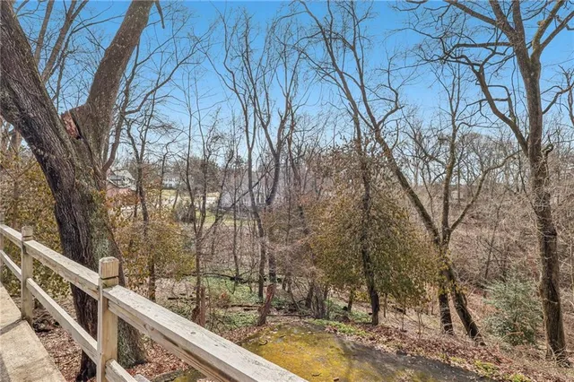 a view of a house with large trees