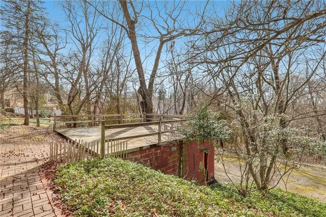 a view of a yard with wooden fence