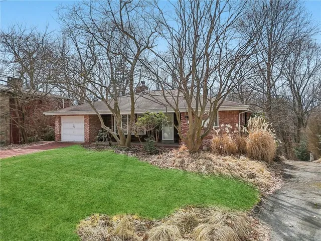 a view of a backyard with table and chairs and a large tree