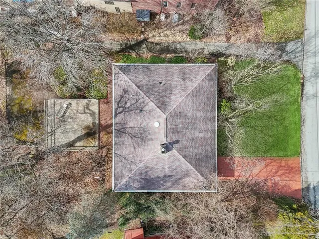 an aerial view of a house with a yard