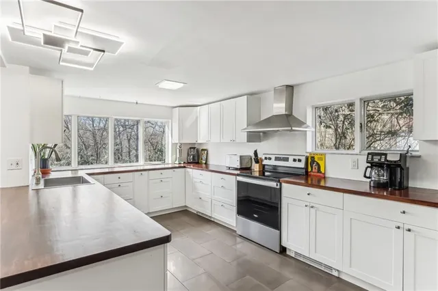 a kitchen with granite countertop white cabinets and white appliances