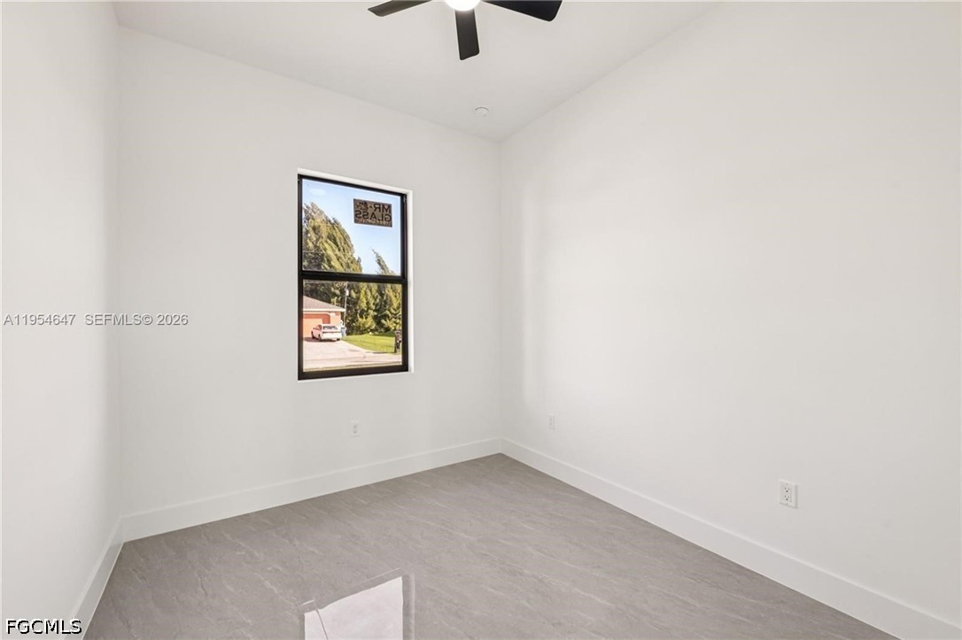 4402 East 19th Street Lehigh Acres, FL 33972 - Photo 16 of 27 an empty room with a window and a ceiling fan