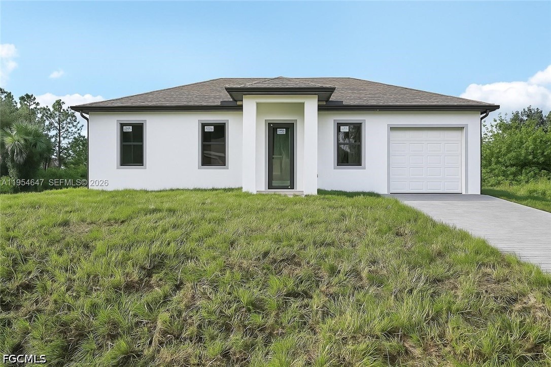 4402 East 19th Street Lehigh Acres, FL 33972 - Photo 2 of 27 a front view of house with yard and green space