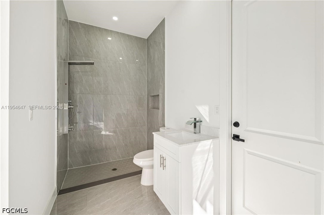 4402 East 19th Street Lehigh Acres, FL 33972 - Photo 21 of 27 a bathroom with a bathtub shower sink mirror and toilet