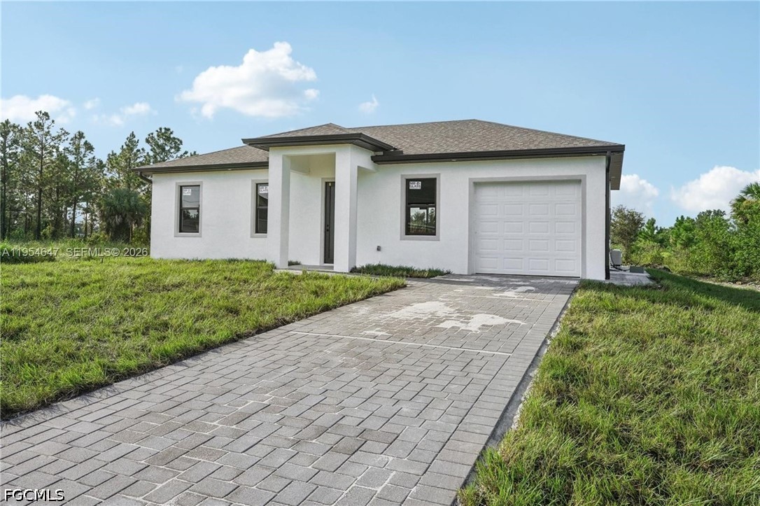 4402 East 19th Street Lehigh Acres, FL 33972 - Photo 22 of 27 a front view of house with yard and green space