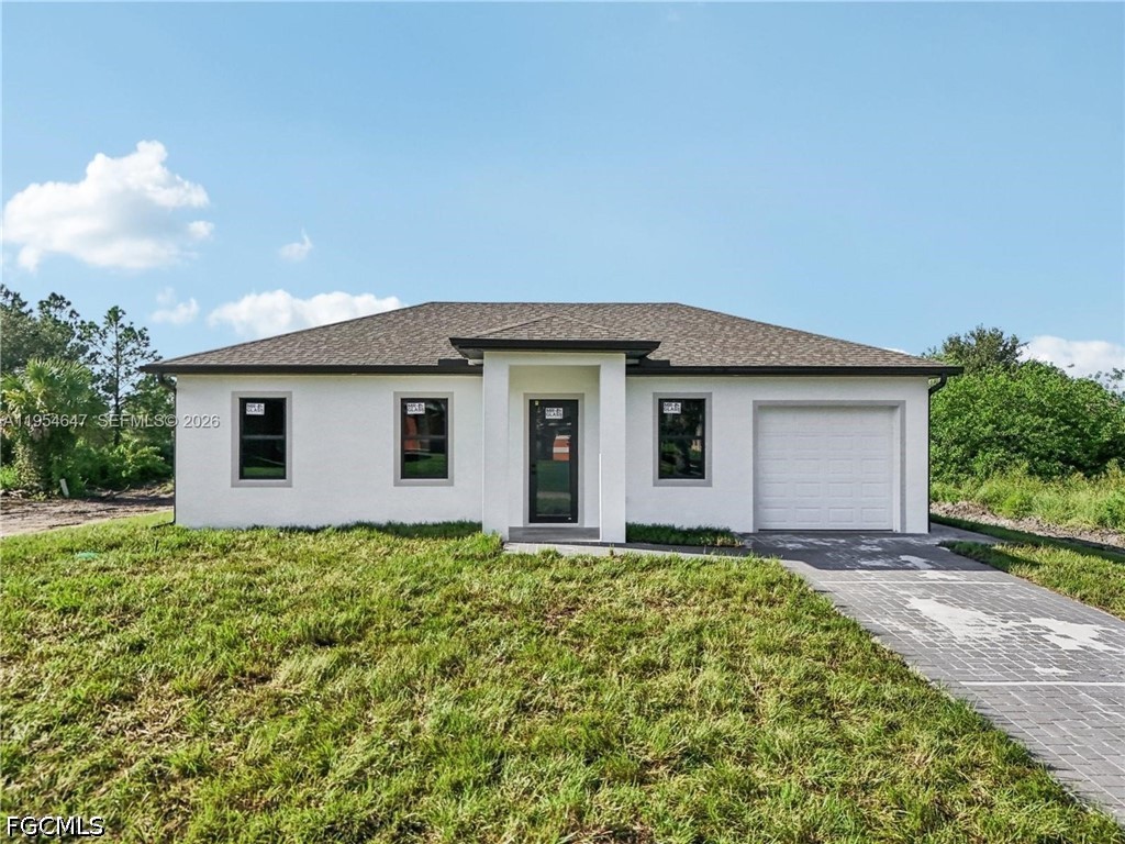 4402 East 19th Street Lehigh Acres, FL 33972 - Photo 23 of 27 a view of a house with yard and a garden