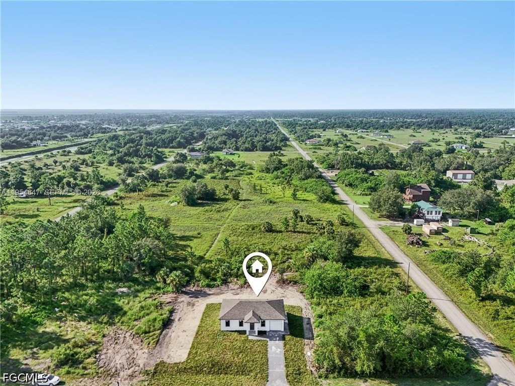 4402 East 19th Street Lehigh Acres, FL 33972 - Photo 25 of 27 an aerial view of a residential houses with outdoor space and street view