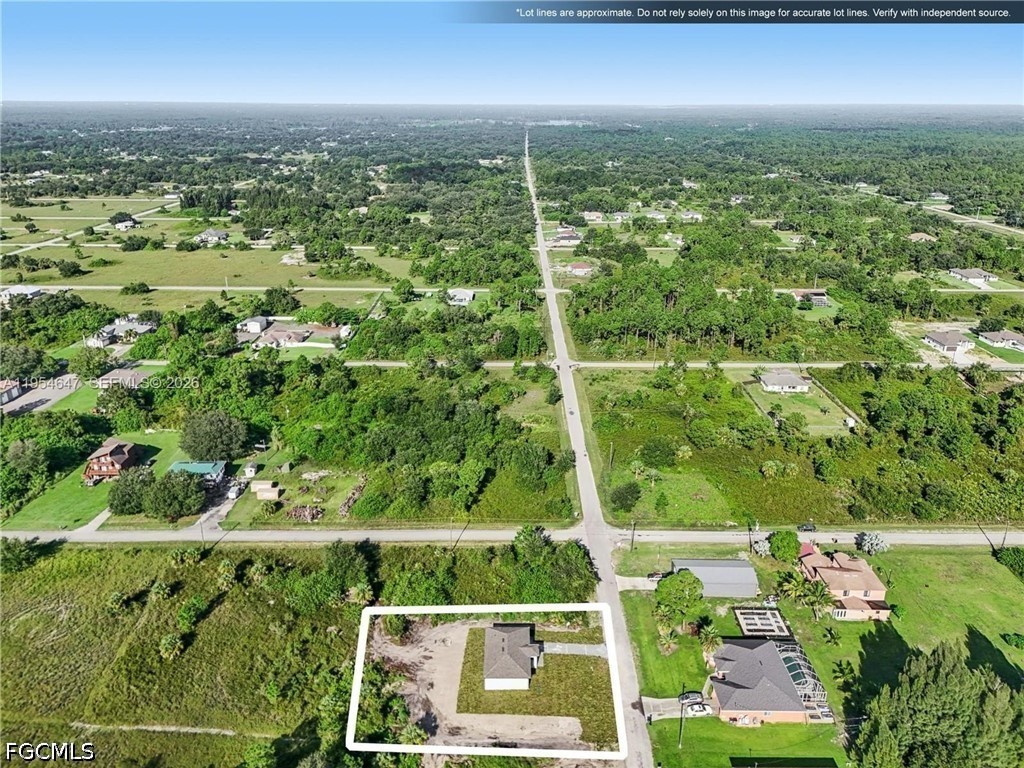 4402 East 19th Street Lehigh Acres, FL 33972 - Photo 26 of 27 an aerial view of residential houses with outdoor space and trees