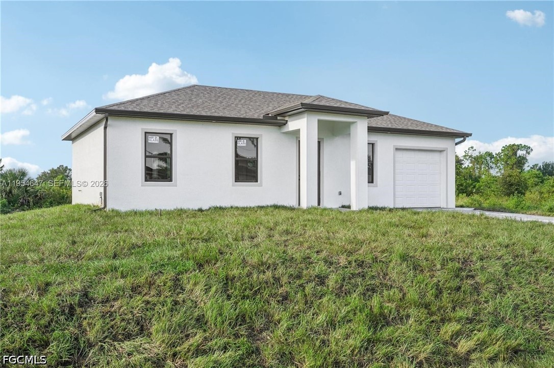 4402 East 19th Street Lehigh Acres, FL 33972 - Photo 3 of 27 a front view of a house with garden
