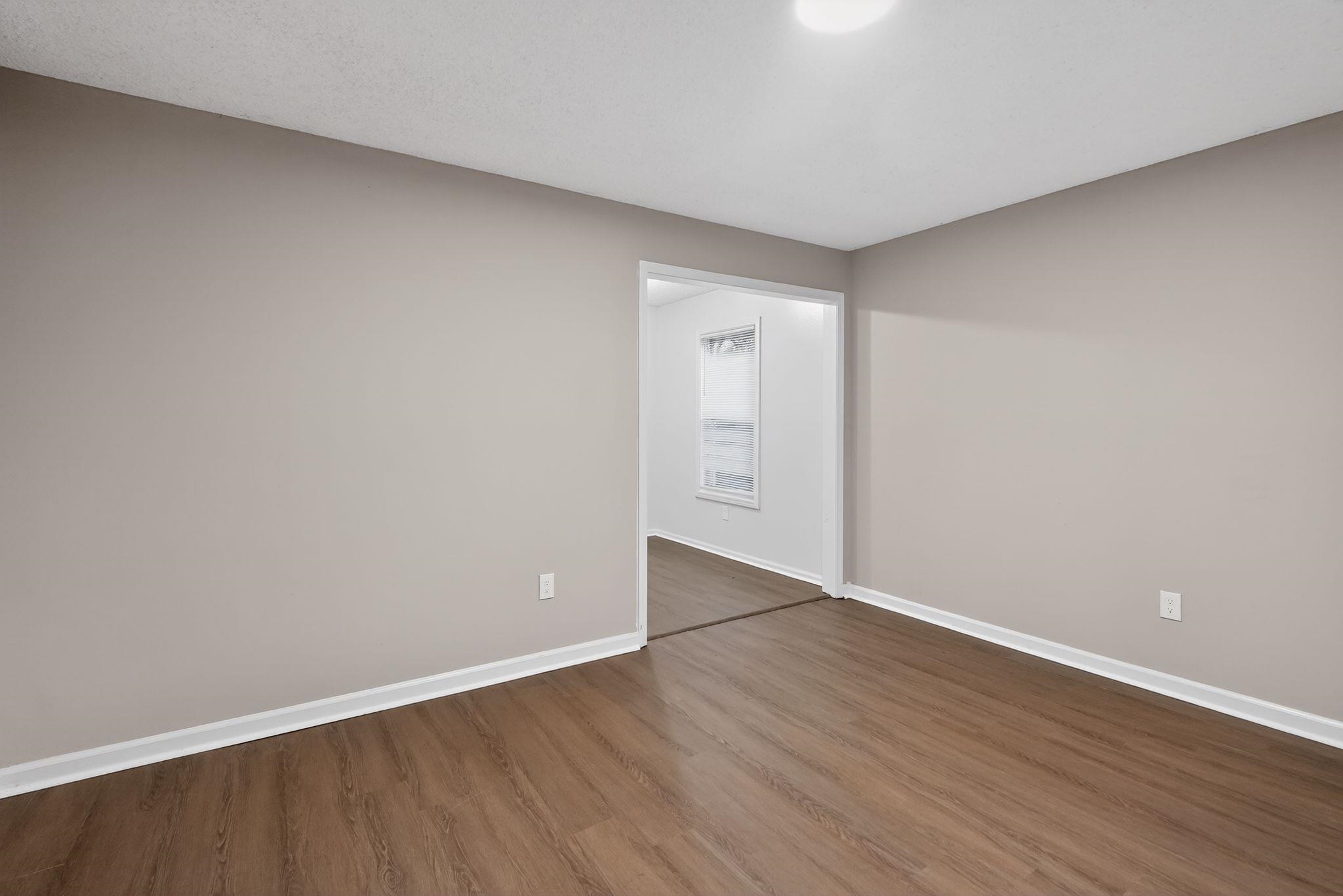 4725 Lofts Road Memphis, TN 38118 - Photo 8 of 32 Empty room featuring baseboards and dark wood-style floors
