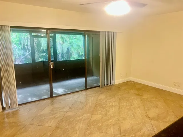 a view of an empty room with glass door
