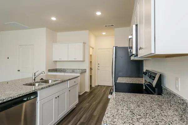 a kitchen with a sink stove and refrigerator