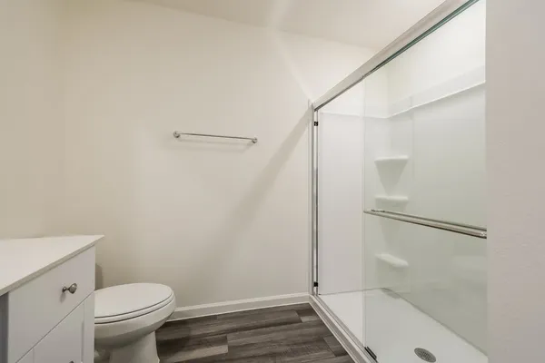 a bathroom with a toilet and a shower