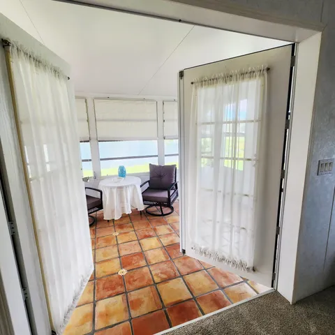 a view of empty room with wooden floor and cabinet