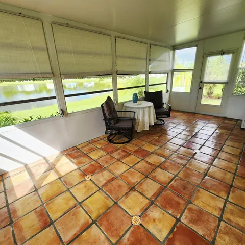a view of an house with backyard porch and furniture