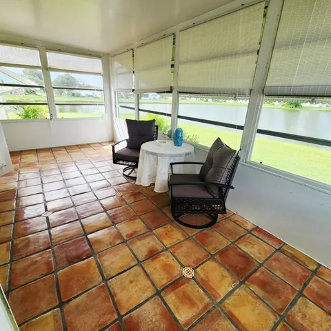 a view of a house entryway door and wooden floor